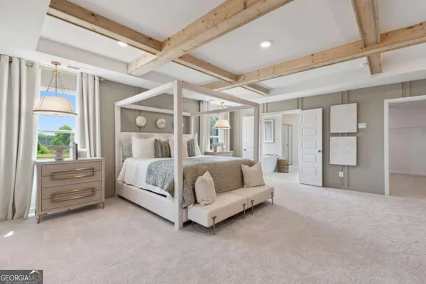 a bedroom with a large bed and a chandelier