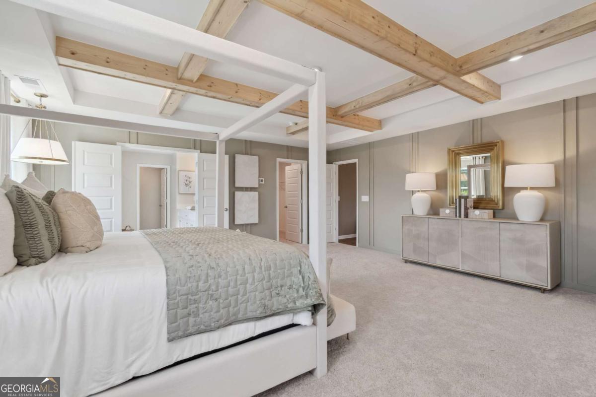 108 Compass Road Hampton, GA 30228 - Photo 39 of 51 a bedroom with a large bed and a chandelier