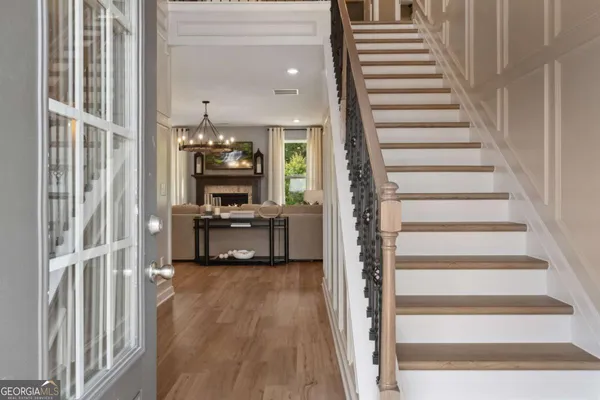 a view of a hallway with wooden floor and entryway