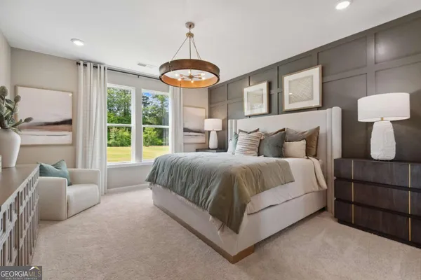 a spacious bedroom with a bed and a large window