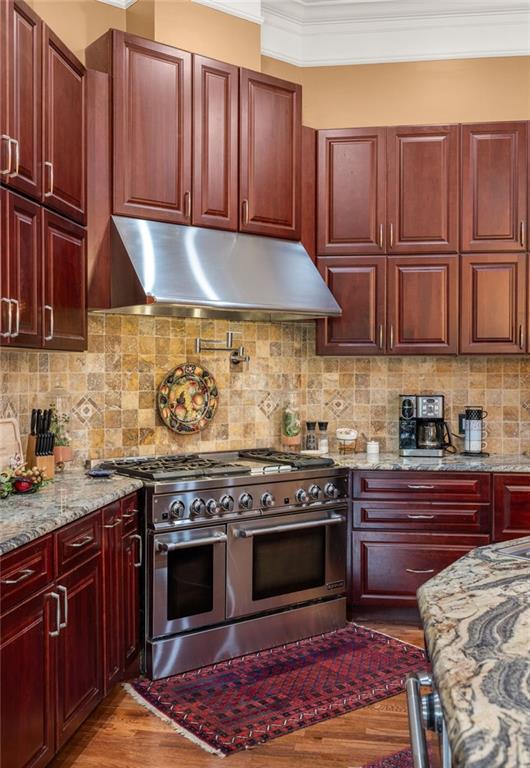 265 Honeysuckle Lane Temple, GA 30179 - Photo 14 of 45 a kitchen with stainless steel appliances granite countertop wooden cabinets stove top oven and granite counter top