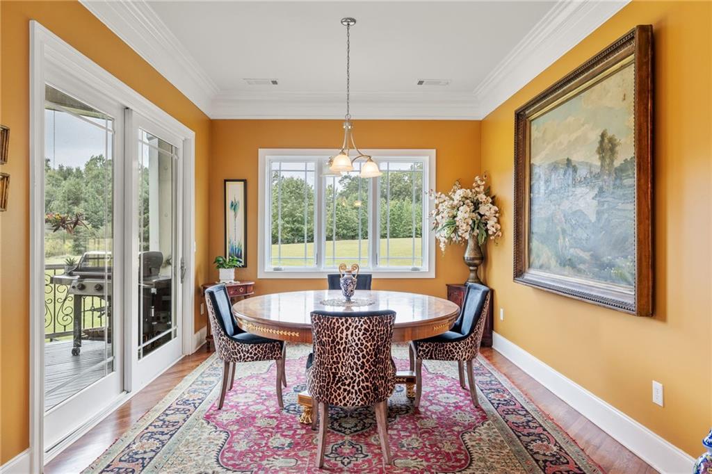 265 Honeysuckle Lane Temple, GA 30179 - Photo 17 of 45 a dining room with furniture wooden floor and a chandelier