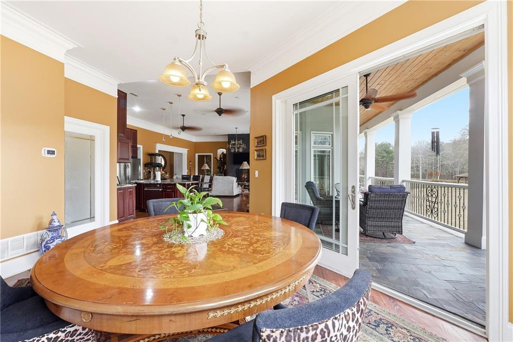 265 Honeysuckle Lane Temple, GA 30179 - Photo 18 of 45 a view of a dining room with furniture wooden floor and a chandelier