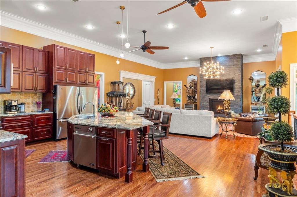 265 Honeysuckle Lane Temple, GA 30179 - Photo 3 of 5 a view of kitchen with stainless steel appliances granite countertop a stove and a wooden floors