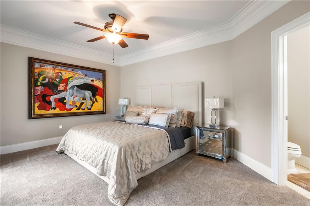 265 Honeysuckle Lane Temple, GA 30179 - Photo 31 of 45 a spacious bedroom with a bed and a painting on the wall