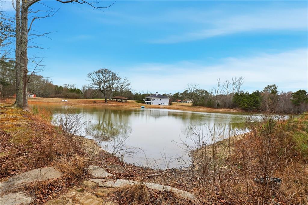 265 Honeysuckle Lane Temple, GA 30179 - Photo 40 of 45 a view of a lake with houses in the back