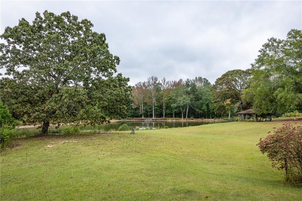 265 Honeysuckle Lane Temple, GA 30179 - Photo 41 of 45 a view of a field with trees in front of it