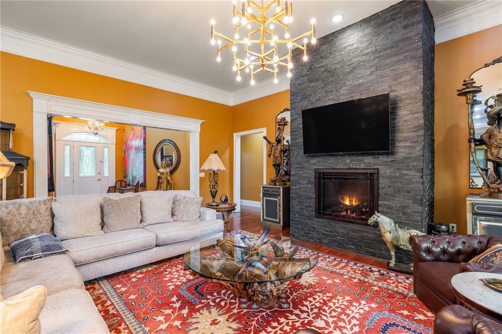 265 Honeysuckle Lane Temple, GA 30179 - Photo 9 of 45 a living room with furniture a flat screen tv and a fireplace