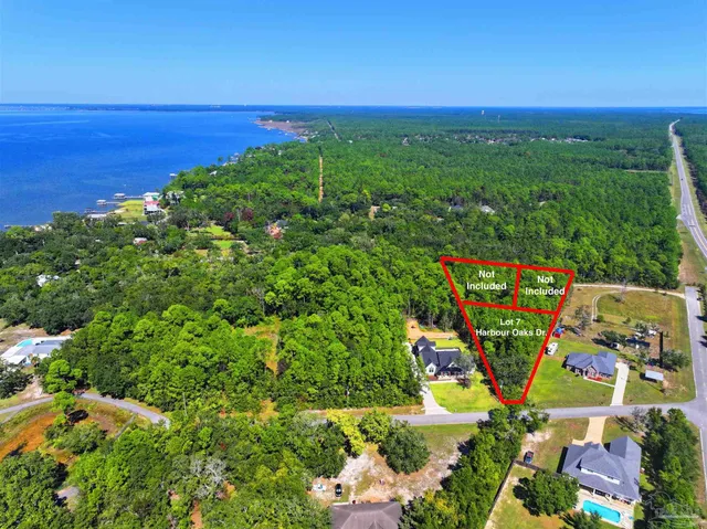 a sign that is sitting on a lush green field