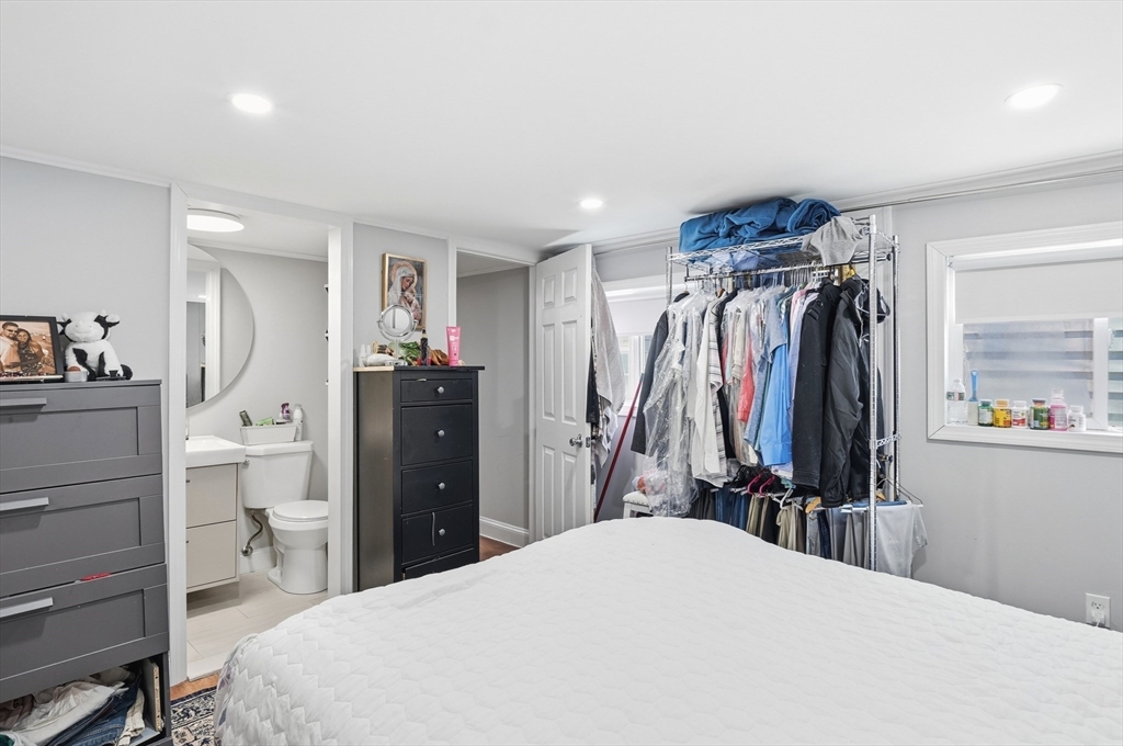 165 Turnpike Road, Unit 7 Westborough, MA 01581 - Photo 13 of 19 a bed room with a bed and a mirror