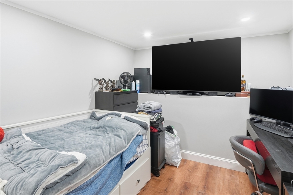 165 Turnpike Road, Unit 7 Westborough, MA 01581 - Photo 15 of 19 a bedroom with a bed and a flat screen tv
