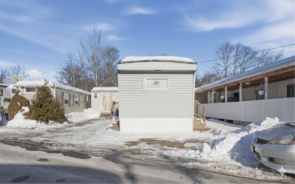 165 Turnpike Road, Unit 7 Westborough, MA 01581 - Photo 2 of 19 a front view of a house with a yard