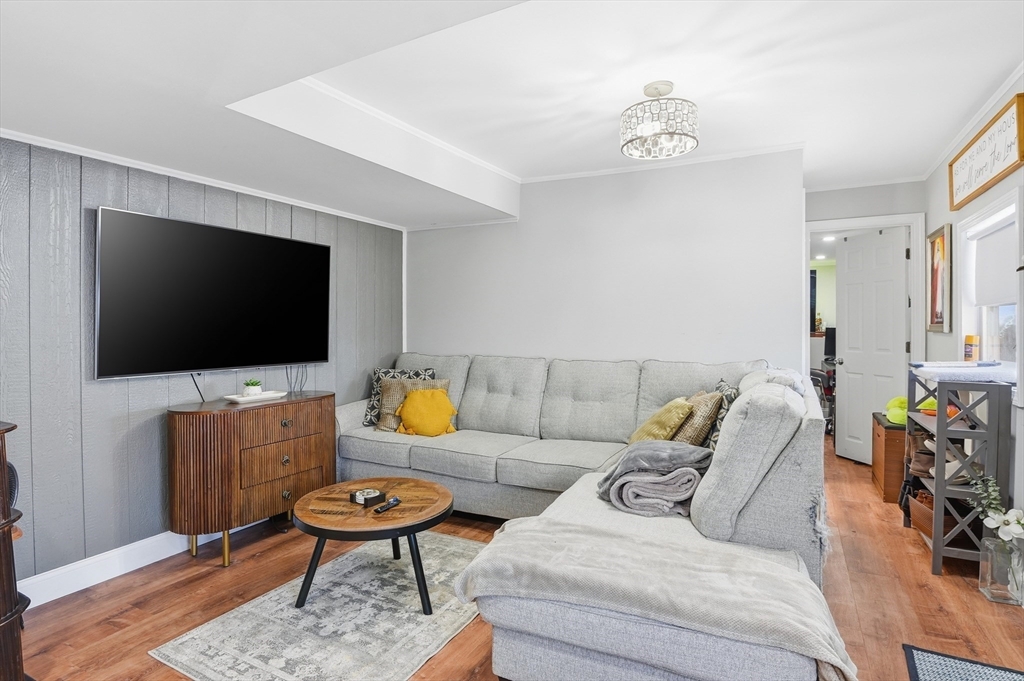 165 Turnpike Road, Unit 7 Westborough, MA 01581 - Photo 3 of 19 a living room with furniture and a flat screen tv