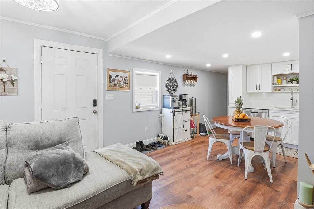 165 Turnpike Road, Unit 7 Westborough, MA 01581 - Photo 5 of 19 a living room with furniture a refrigerator and a dining table