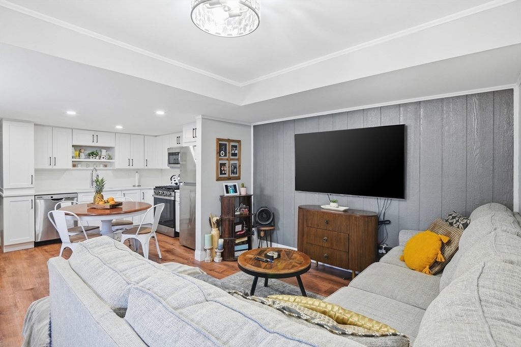 165 Turnpike Road, Unit 7 Westborough, MA 01581 - Photo 6 of 19 a living room with furniture and a flat screen tv