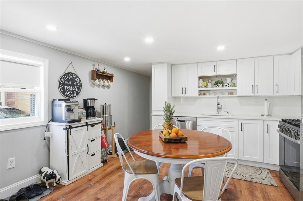 165 Turnpike Road, Unit 7 Westborough, MA 01581 - Photo 8 of 19 a kitchen with granite countertop a sink cabinets and wooden floor
