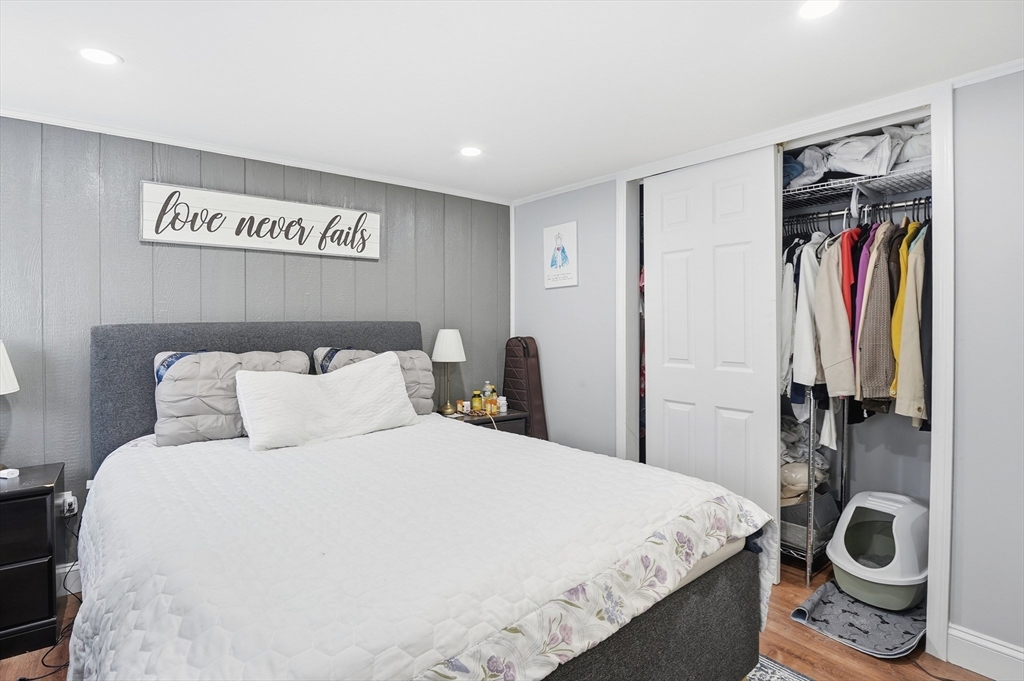 165 Turnpike Road, Unit 7 Westborough, MA 01581 - Photo 10 of 19 a bedroom with a bed and a large mirror