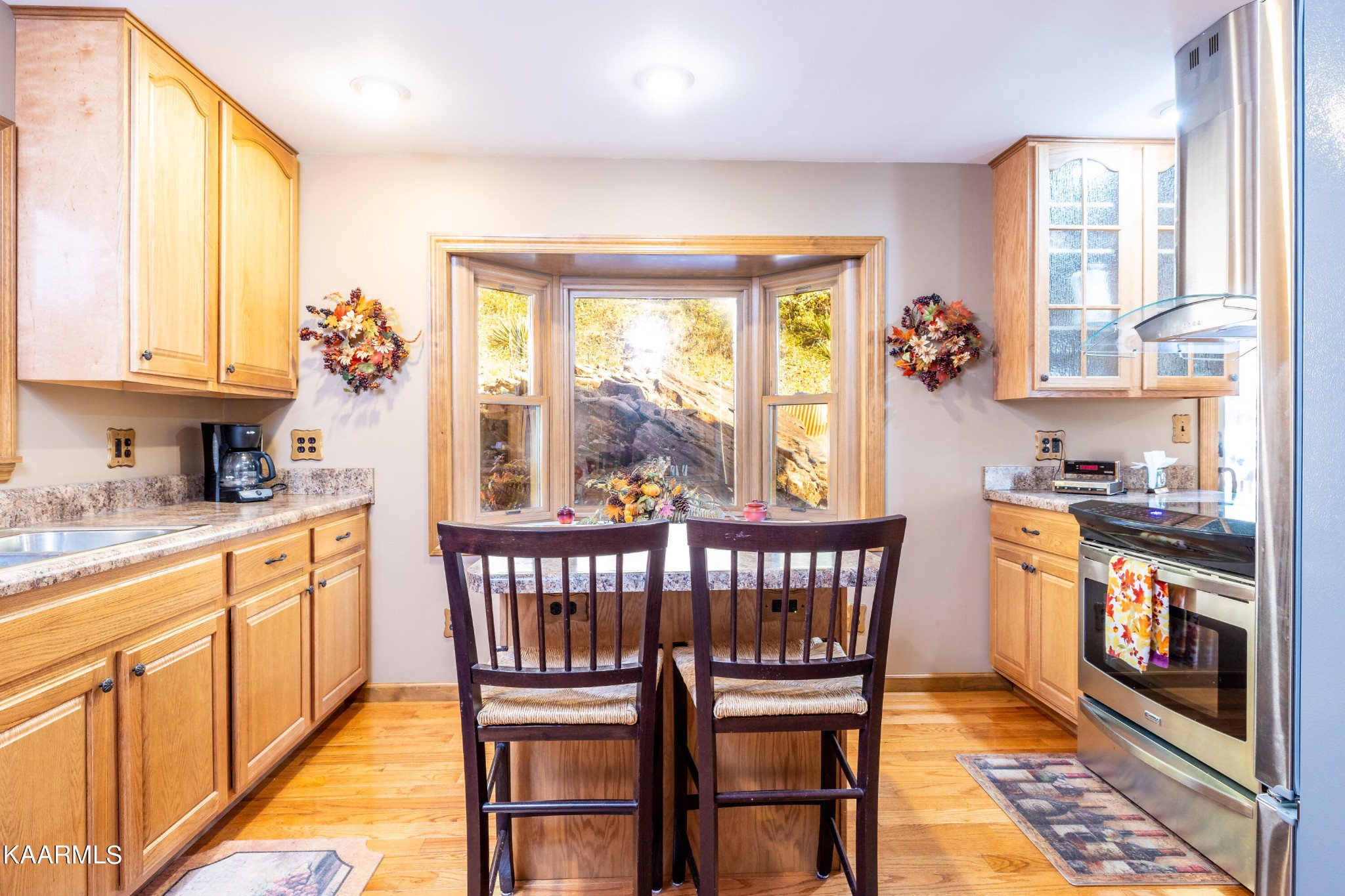 710 Scenic River Road Madisonville, TN 37354 - Photo 15 of 43 a kitchen with stainless steel appliances granite countertop a stove a sink dishwasher and a dining table with garden view