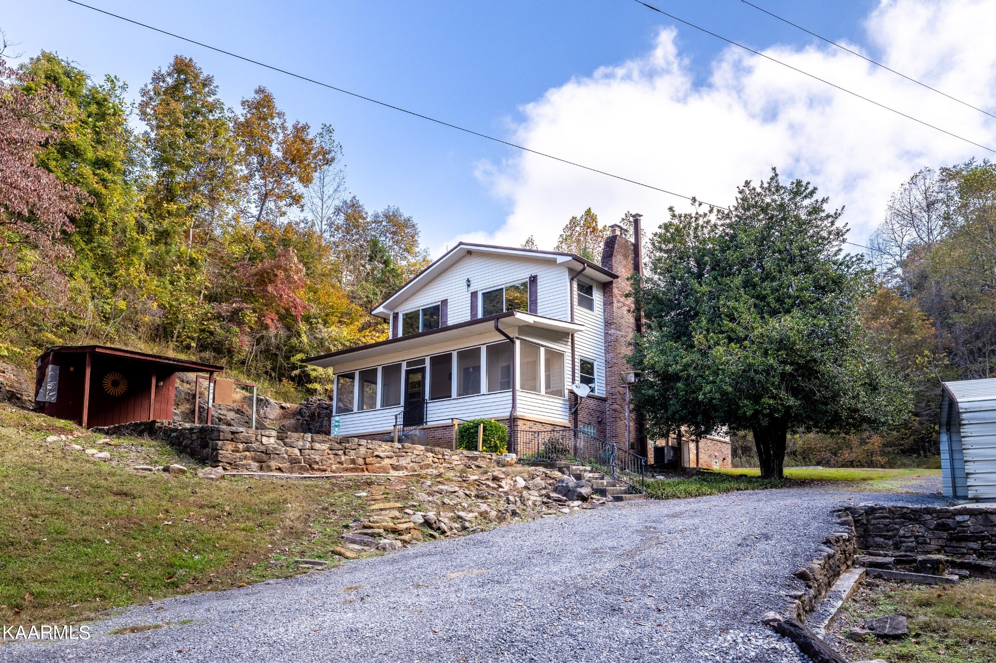 710 Scenic River Road Madisonville, TN 37354 - Photo 5 of 43 a front view of a house with a yard and large trees