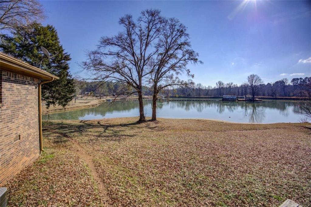 40 Spillers Lane Covington, GA 30014 - Photo 32 of 42 a view of a lake with a house in the background