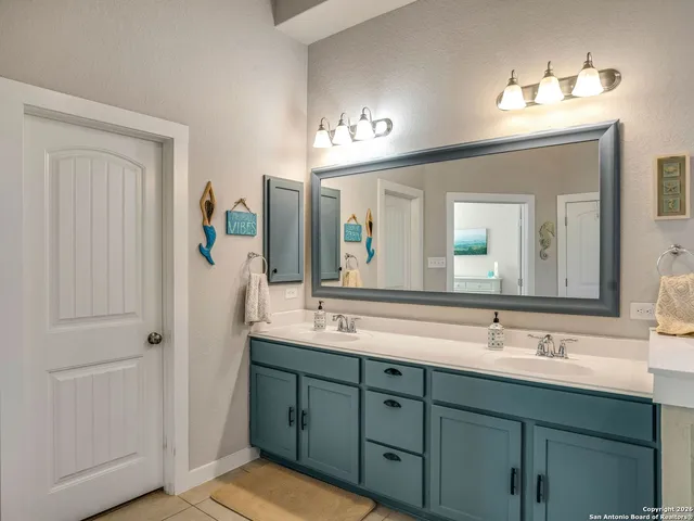 a bathroom with a double vanity sink and a mirror