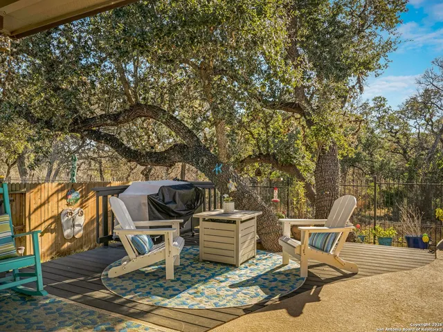 a view of a chairs and table in backyard