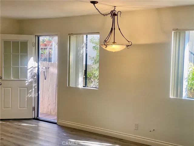 a view of a room with wooden floor and windows