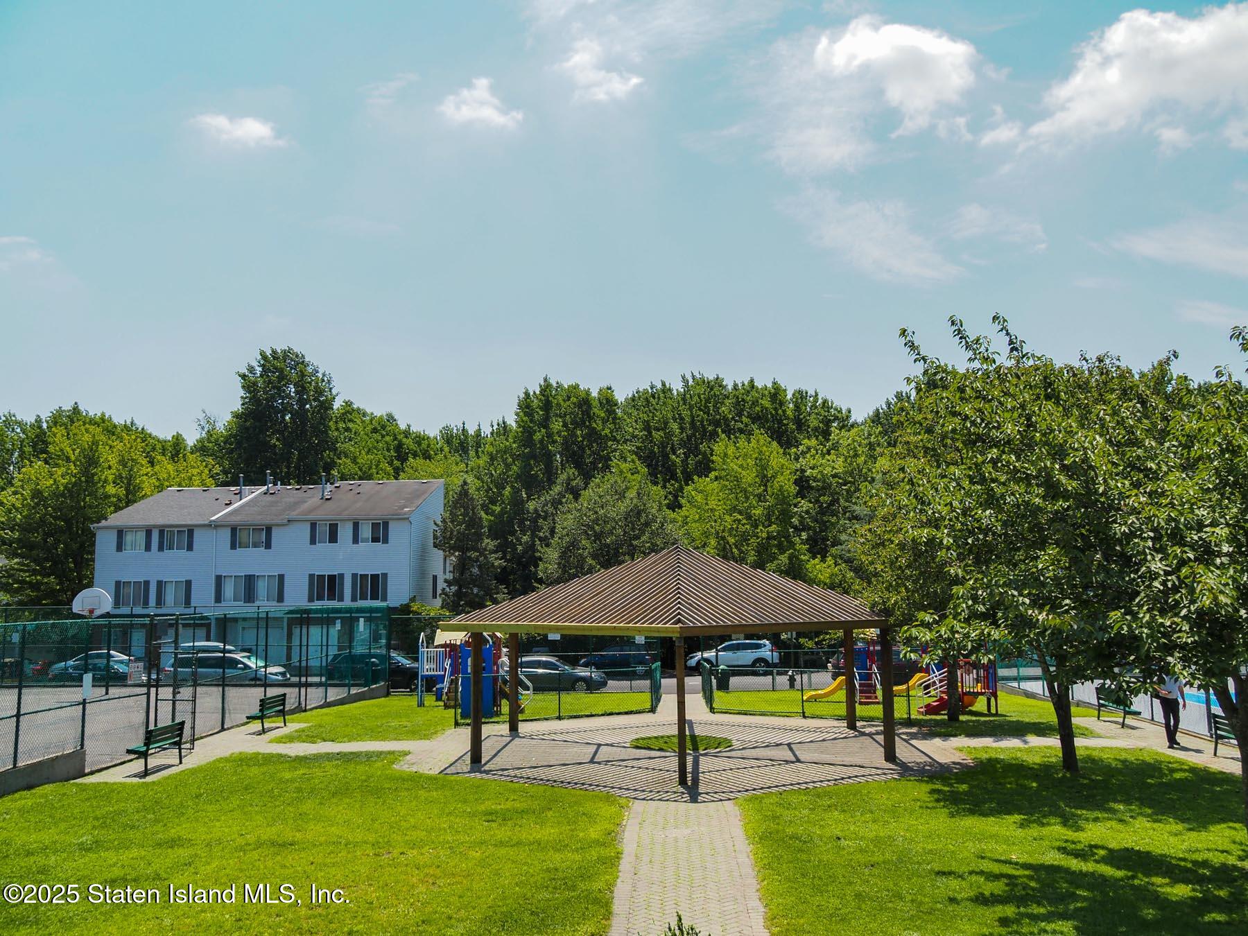 214 Ilyssa Way Staten Island, NY 10312 - Photo 11 of 22 a swimming pool with outdoor seating and yard