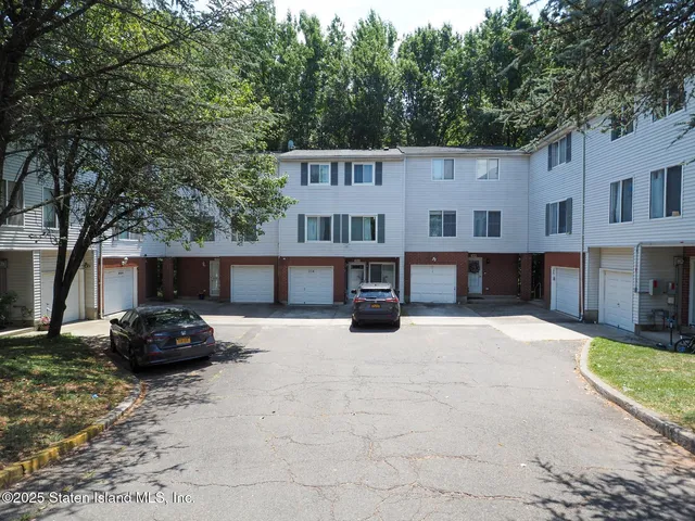 a car parked in front of a white house