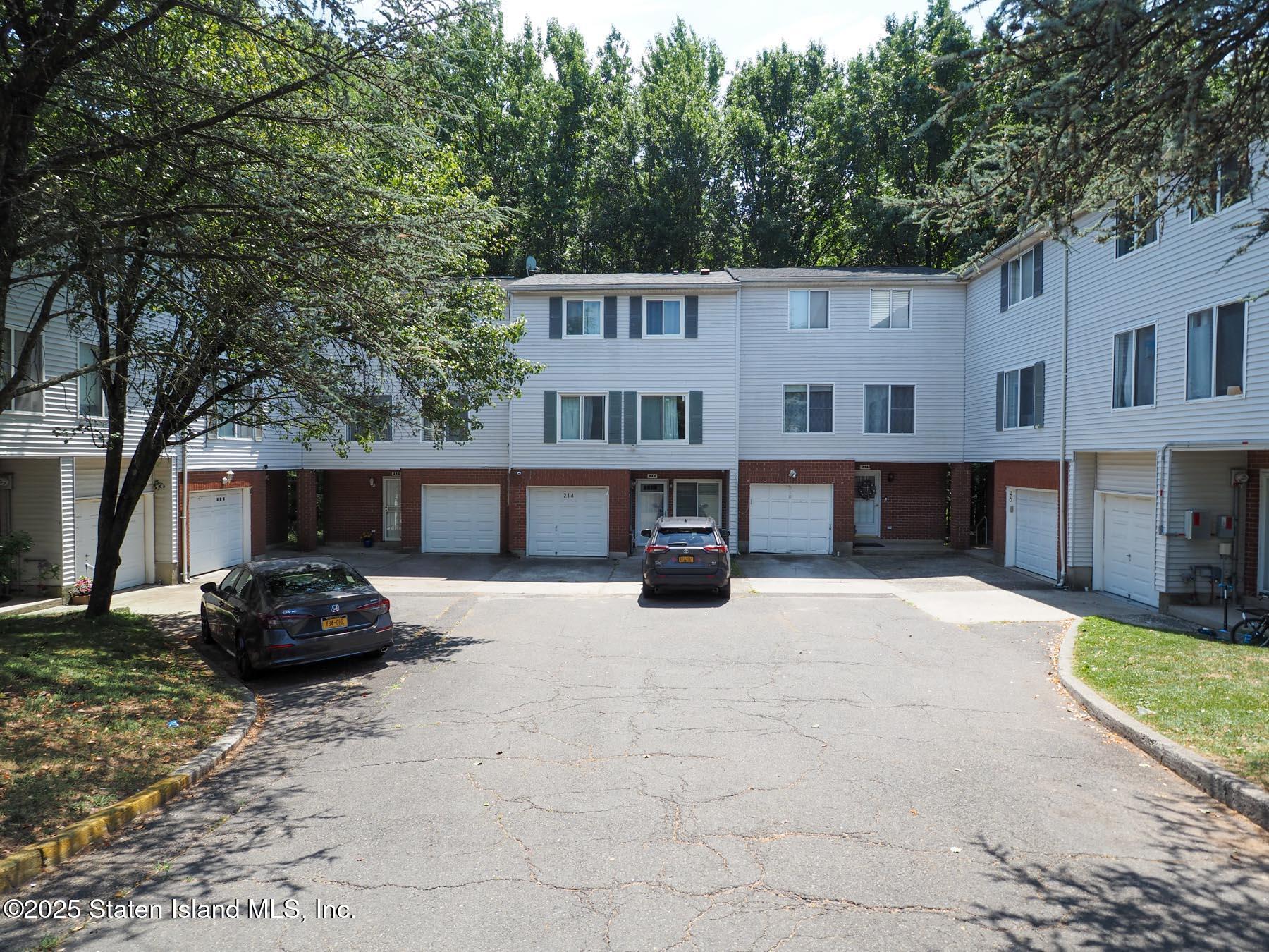 214 Ilyssa Way Staten Island, NY 10312 - Photo 2 of 22 a car parked in front of a white house