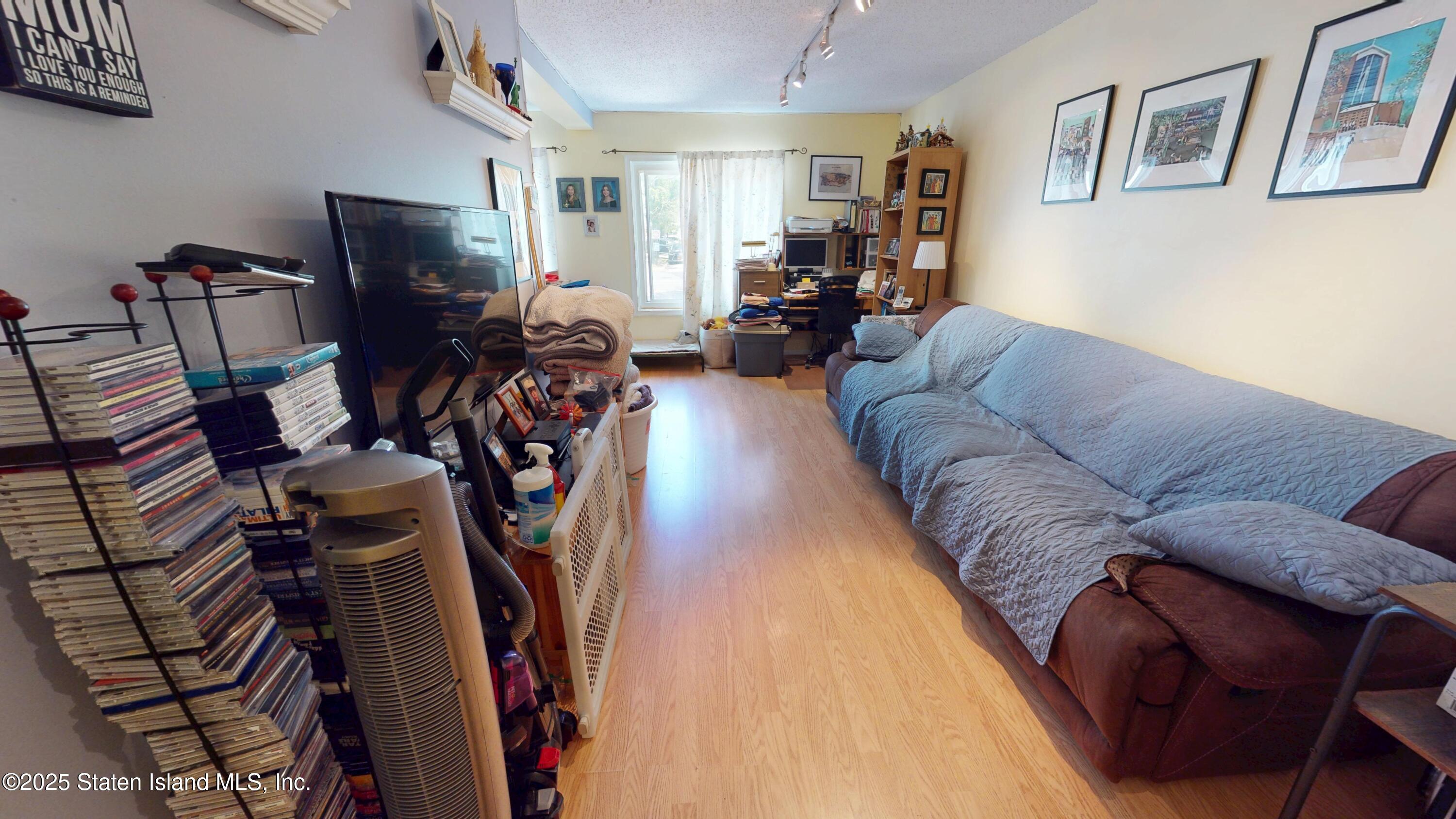 214 Ilyssa Way Staten Island, NY 10312 - Photo 4 of 22 a living room with furniture a flat screen tv and a window