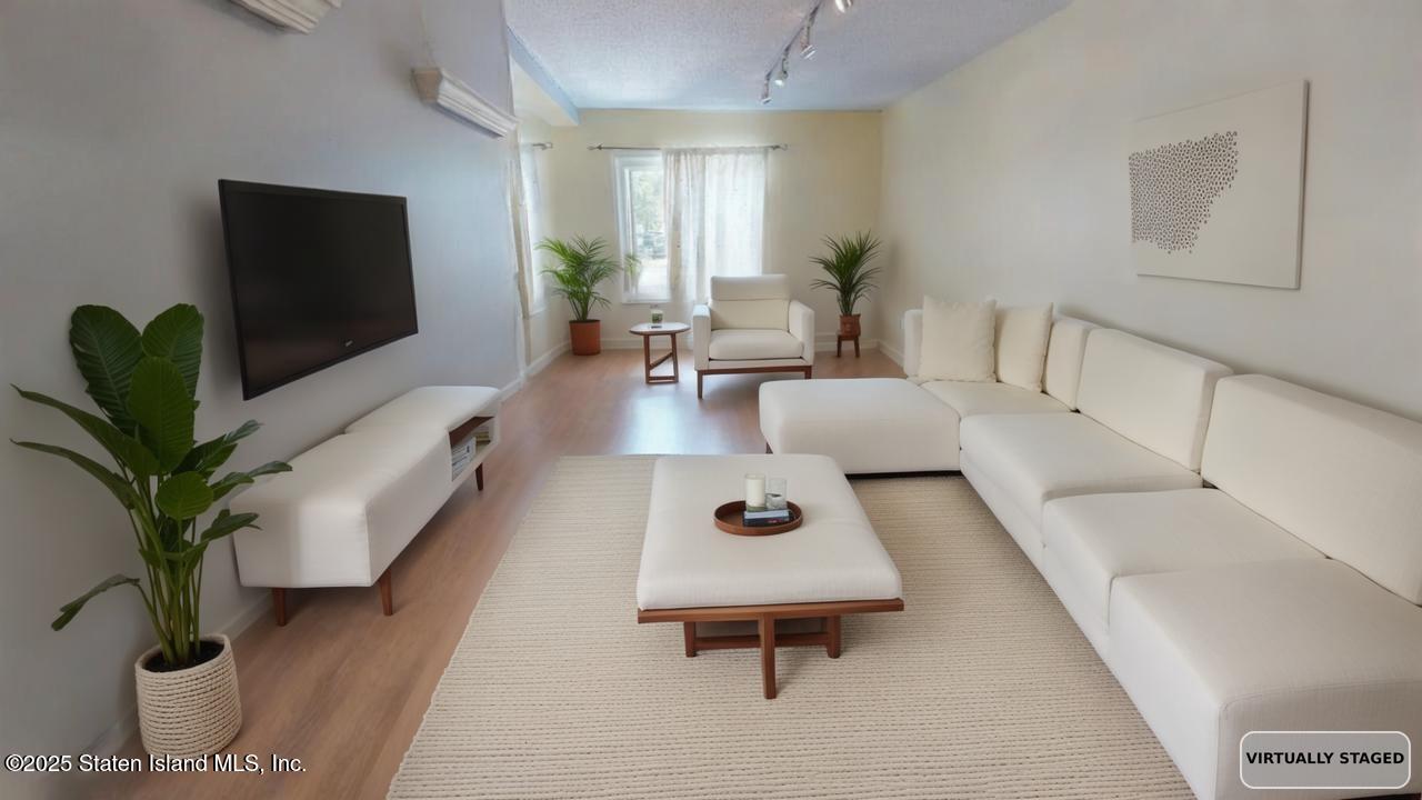 214 Ilyssa Way Staten Island, NY 10312 - Photo 5 of 22 a living room with furniture and a flat screen tv