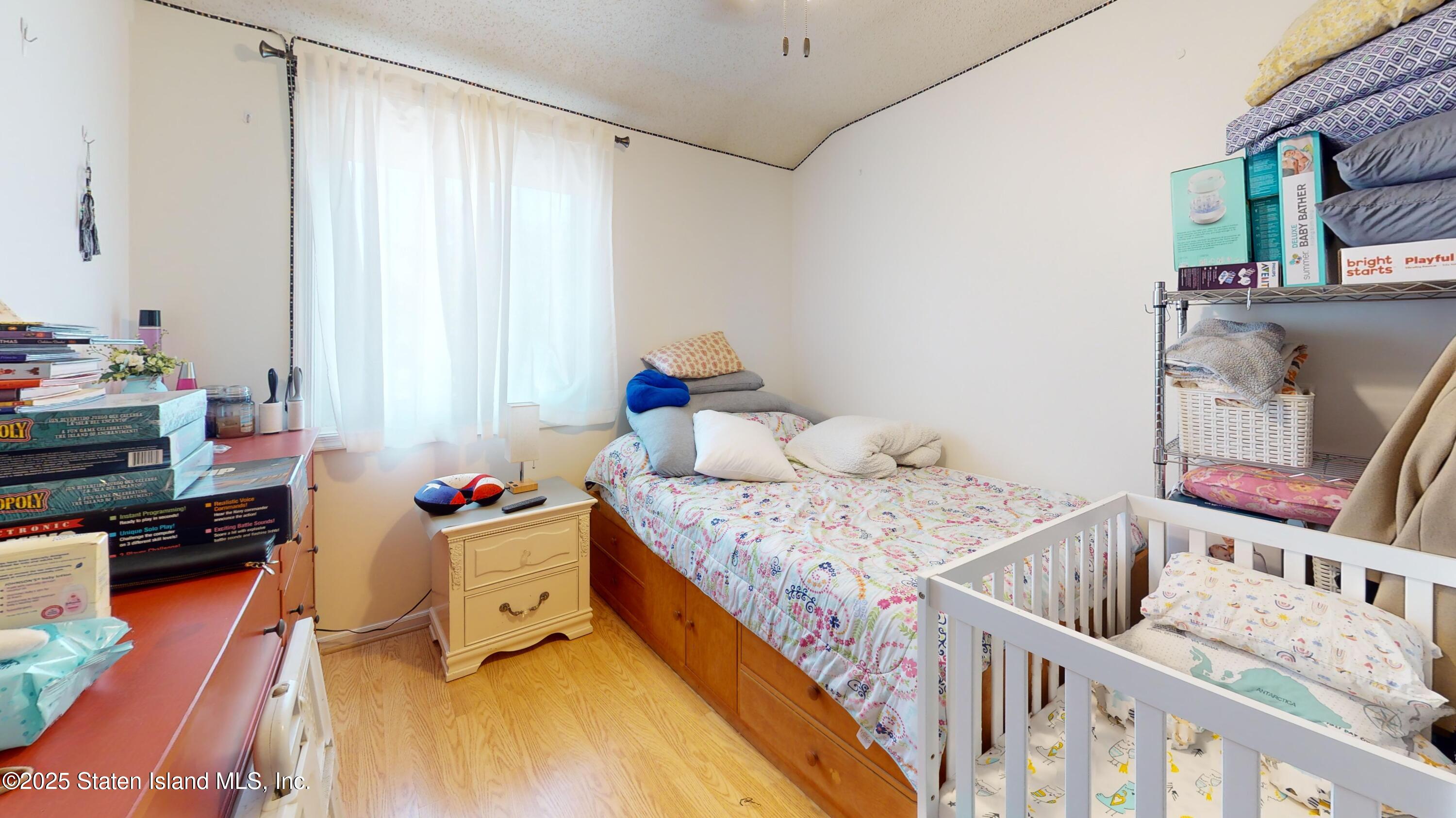 214 Ilyssa Way Staten Island, NY 10312 - Photo 6 of 22 a bedroom with furniture and a window