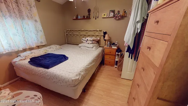 a bed sitting in a bedroom next to a small bathroom