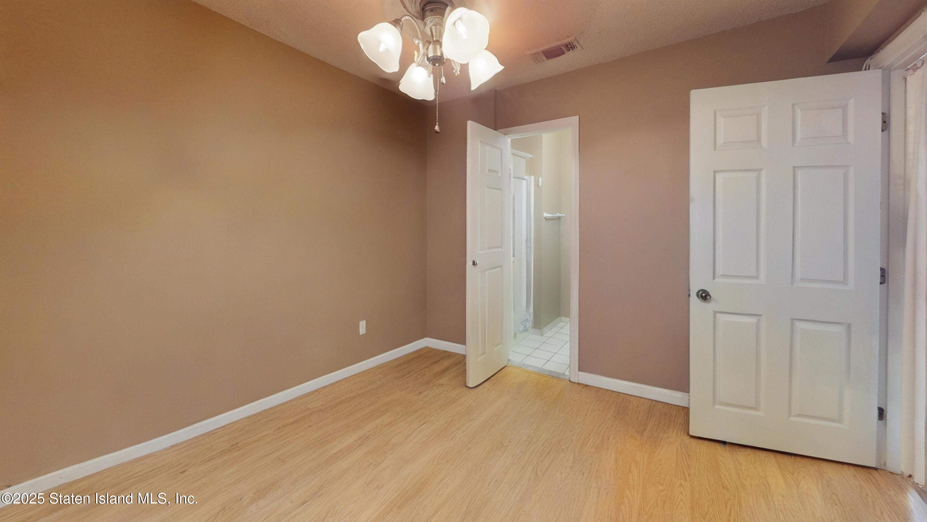 214 Ilyssa Way Staten Island, NY 10312 - Photo 8 of 22 wooden floor in an empty room