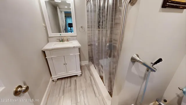 a bathroom with a sink a mirror and shower