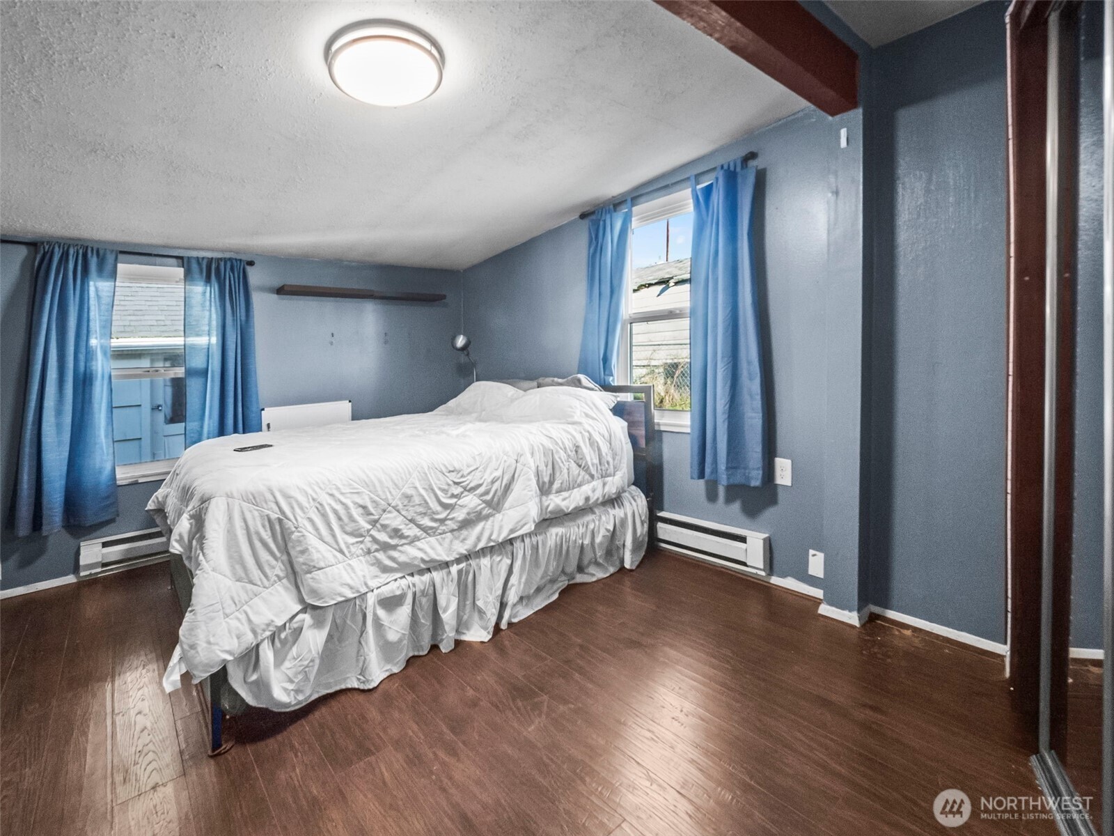 1022 Sheridan Road Bremerton, WA 98310 - Photo 16 of 28 a bedroom with a bed and wooden floor