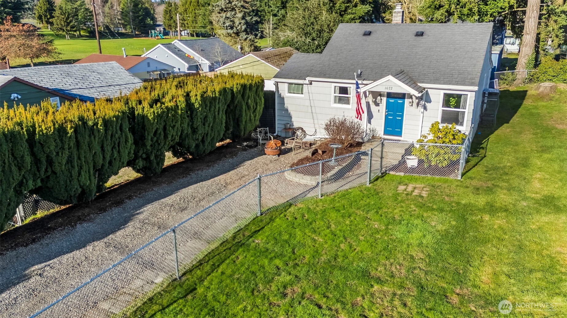 1022 Sheridan Road Bremerton, WA 98310 - Photo 6 of 28 a view of a patio with table and chairs under an umbrella