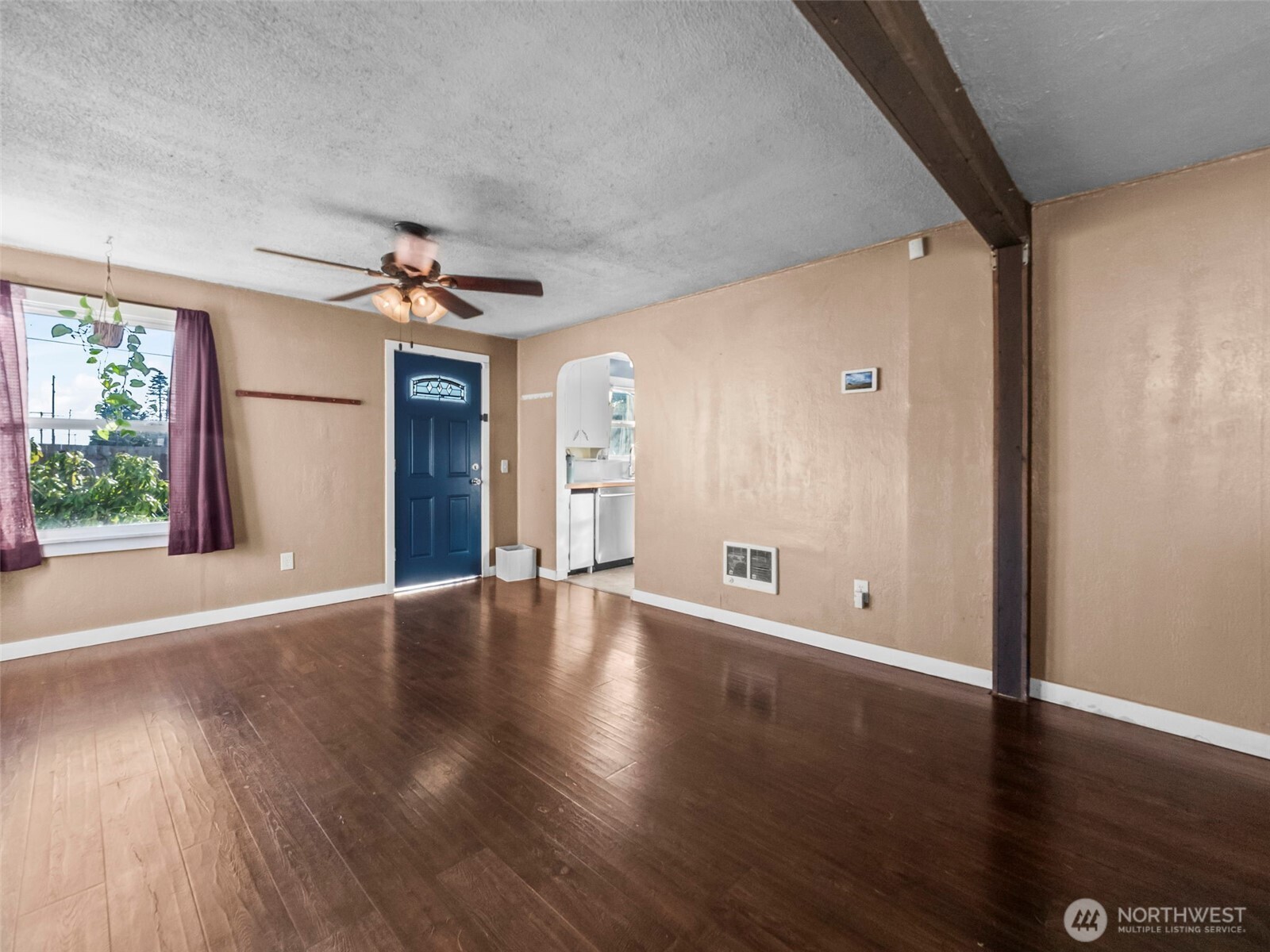 1022 Sheridan Road Bremerton, WA 98310 - Photo 10 of 28 a view of an empty room with wooden floor and a window