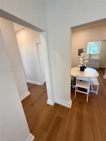 a bedroom with a bed a dresser next to a window