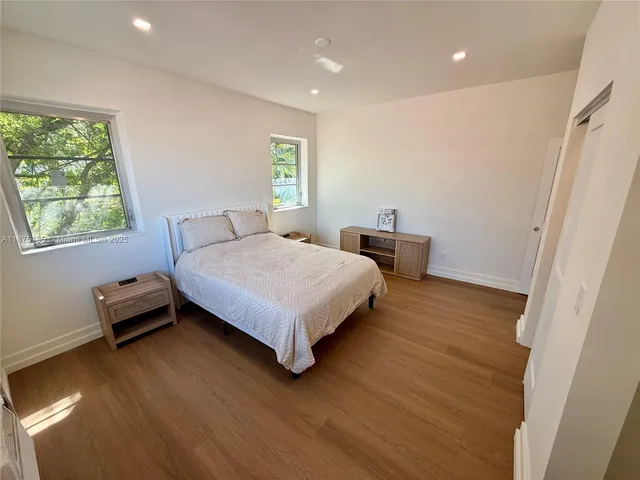 a bedroom with a bed and cabinets