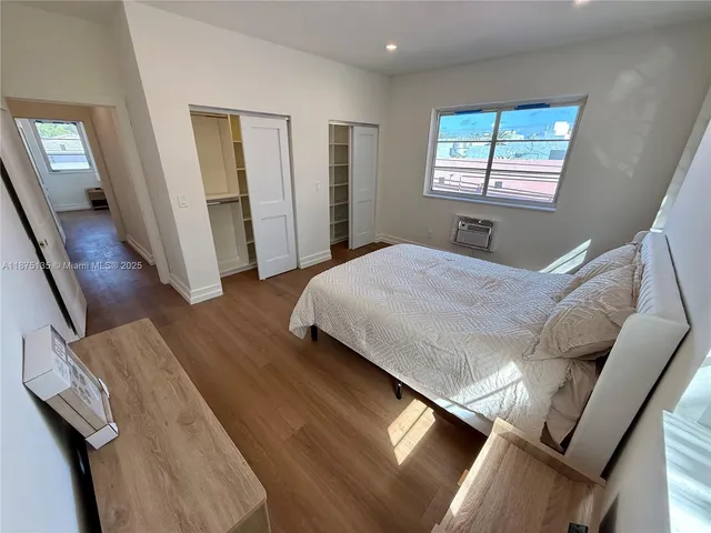 an empty room with wooden floor and closet