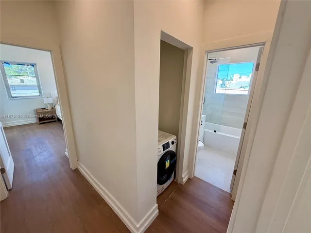 a bathroom with a tub sink and mirror
