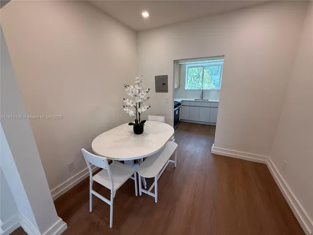 a dining room with furniture and wooden floor