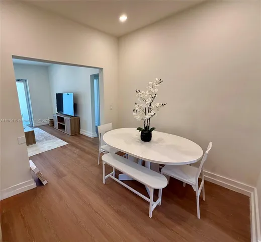 a kitchen with sink a microwave a stove and white cabinets