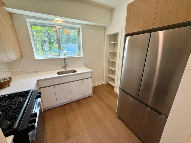 a view of a livingroom with wooden floor and a couch
