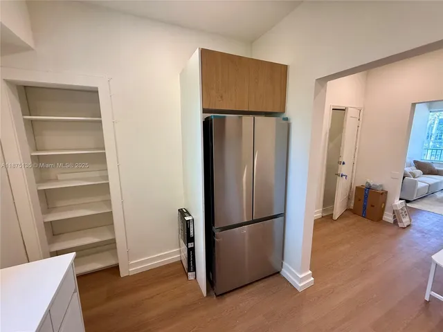 a kitchen with a stove a microwave and a refrigerator