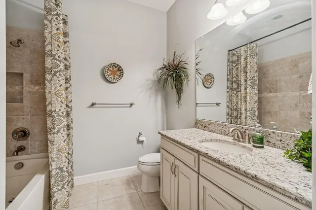 a bathroom with a tub sink and mirror
