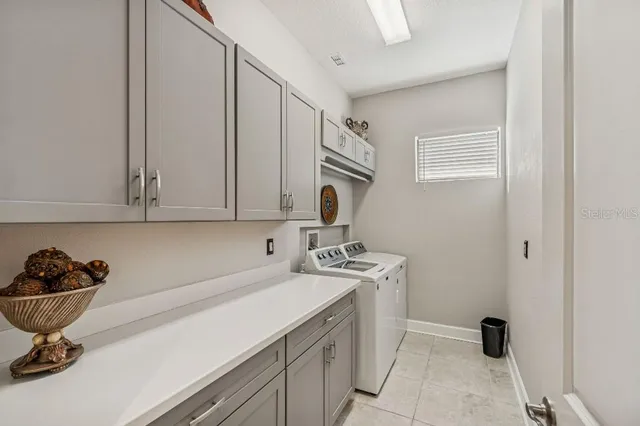 a room with mirror and cabinets
