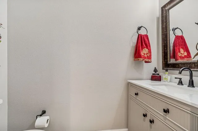 a view of a dining room and livingroom with furniture wooden floor a chandelier